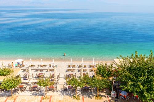 an aerial view of a beach with tables and chairs at Akrata Beach Hotel in Akrata