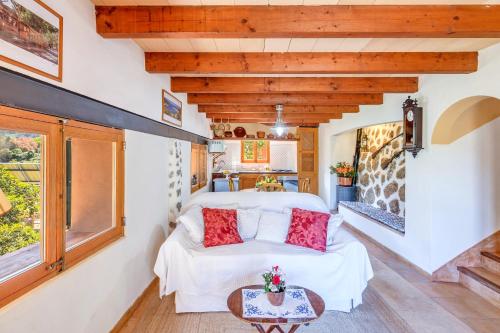 a room with a white bed and a table at Casa Catalina in Sóller