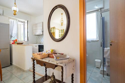 a bathroom with a table with a mirror on the wall at Villa Minetta in Leporano Marina