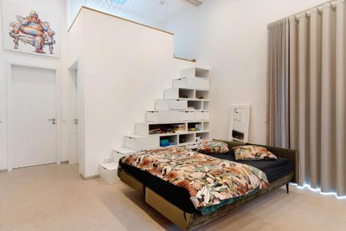 a bedroom with a bed and a stair case at Gästehaus Achern in Achern