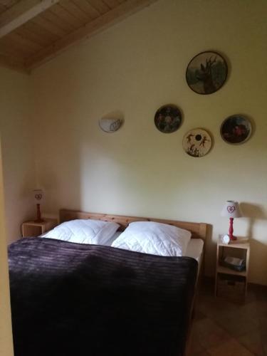 a bedroom with a bed with plates on the wall at Jagdhaus Franz in Krahne