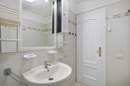 a white bathroom with a sink and a mirror at Ceyla in Arona