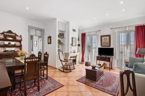 a living room with a couch and a table at Estoi Heritage in Estói