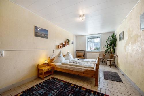 a bedroom with a bed and a table and chairs at Ferienwohnung Wiesental in Meisburg