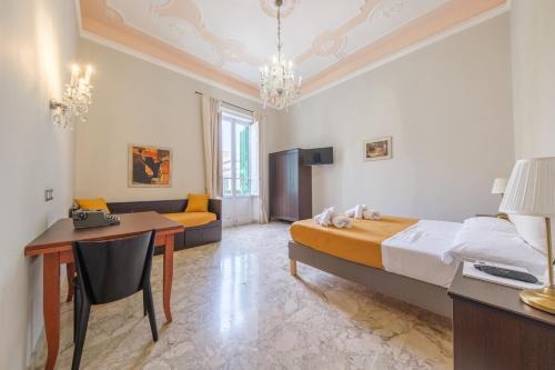 a bedroom with a bed and a table and a desk at Epoque in Messina