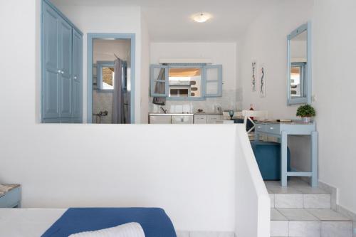a white room with a bed and a bathroom at Pico Bello Patmos 10 in Patmos