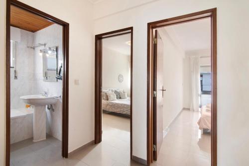 a bathroom with a sink and a mirror at Matinhos House in Faro
