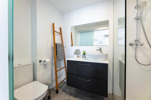 a bathroom with a sink and a toilet and a mirror at Voramar in Pollença