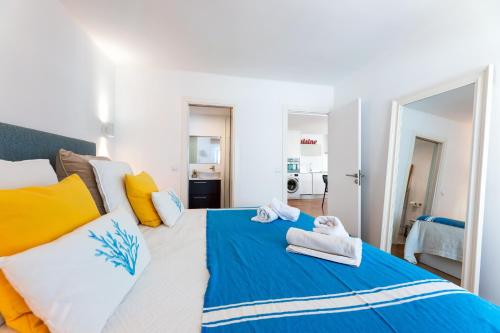 a bedroom with a large bed with towels on it at Voramar in Pollença