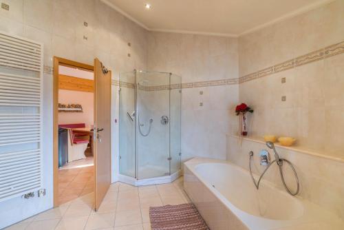 a large bathroom with a tub and a shower at Haus am Bächel in Lauf