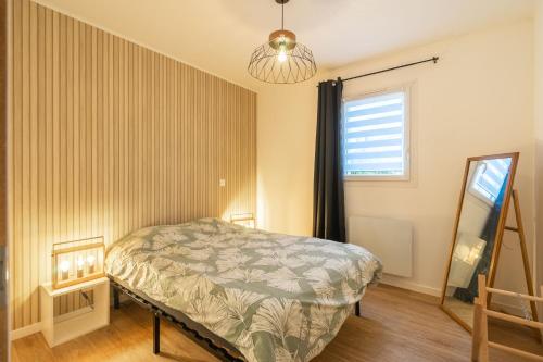 a bedroom with a bed and a window at L'instant fleuri in Saint-Hippolyte
