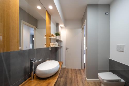 a bathroom with a white toilet and a sink at Casa Cenate in Nardò