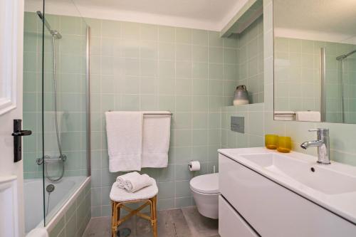 a bathroom with a sink and a toilet and a shower at Casa O12 in Vilamoura