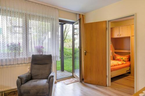 a bedroom with a chair and a bed and a window at Ferienwohnung Wagner mit 35 qm Fr in Bad Bellingen