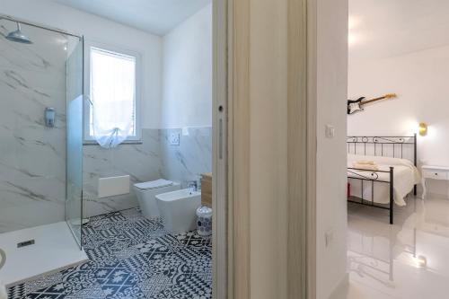 a white bathroom with a shower and a toilet at New and Vintage Villa - Anni 50' in Alghero