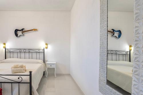 a mirror in a room with two beds at New and Vintage Villa - Anni 50' in Alghero