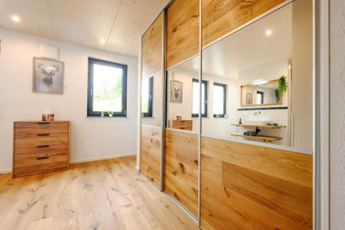 a bathroom with wooden walls and a glass wall at Ferienwohnung Schwarzwald Penthus in Kappelrodeck