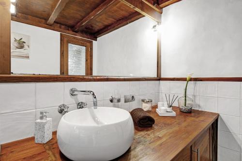 a bathroom with a large white sink on a wooden counter at El Portillo 1 in Buenavista del Norte