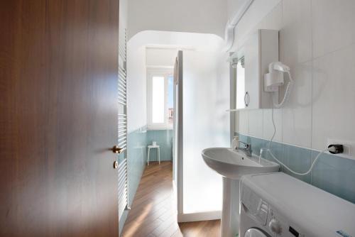 a bathroom with a sink and a mirror at Bilocale Corosu con 2 balconi in Varazze