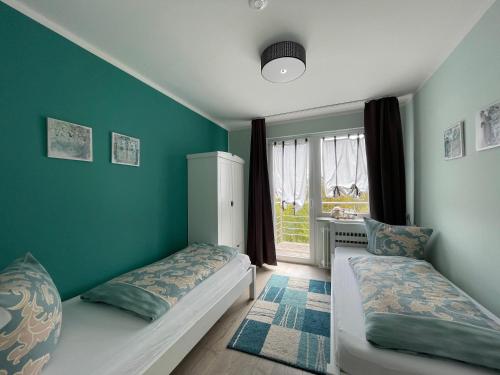 a bedroom with two beds and a window at Ferienhaus Sweethome - mit Garten in Bad Sachsa