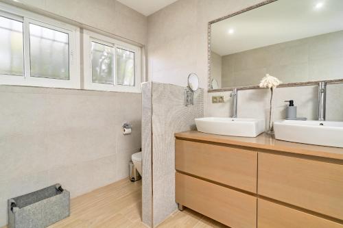 a bathroom with two sinks and a mirror at Villa Dopimar in Rincón de la Victoria