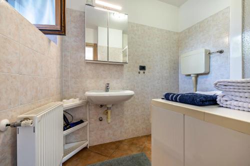 a bathroom with a sink and a mirror at Panoramic Green Studio in Malcesine