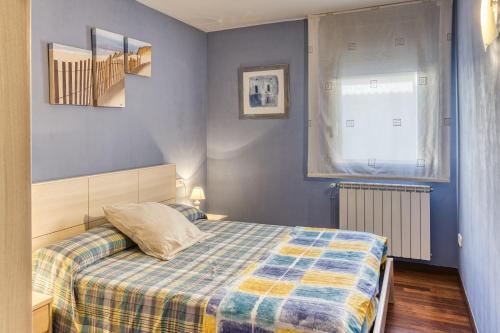a small bedroom with a bed and a window at Cal Tatanet in Sant Pau de Segúries