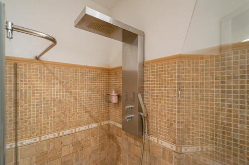 a shower with a glass door in a bathroom at L de Alborada del Eo in Villameitide