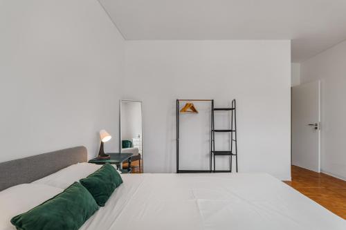 a bedroom with a bed with green pillows at Palmela Sunset Villa in Quinta do Anjo