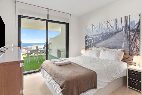 a bedroom with a large bed and a large window at Hollywood A111 in Mijas Costa