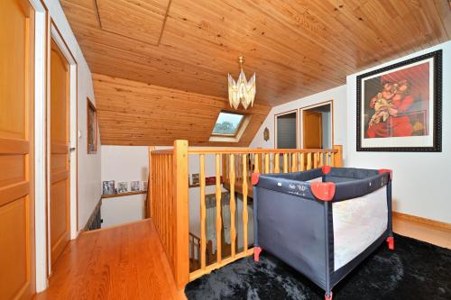 a room with a crib in a house at Jolie Maison Vallee D'aure 4étoiles in Pailhac