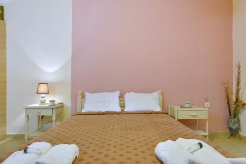 a bedroom with a large bed with two white tables at Erietas House in Ágios Matthaíos