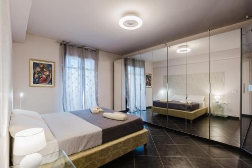 a bedroom with two beds and a large mirror at Casa Cuore in Marsala