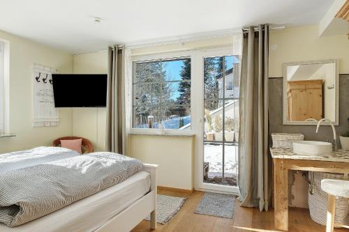 a bedroom with a bed and a window at Ferienhaus Feldberg im Schwarzwald in Mittelfalkau