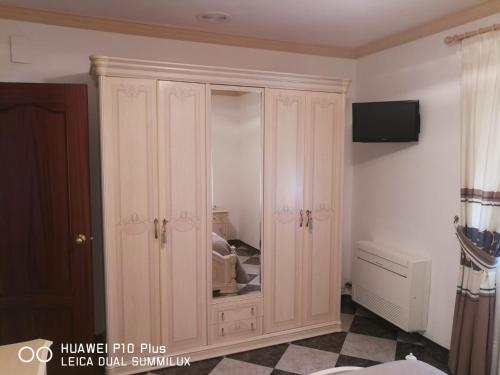 a white cabinet with a mirror in a room at Casa José Romero in Arriate