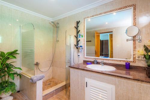 a bathroom with a sink and a shower and a mirror at Casa Paqui Alcudia in Port d'Alcudia