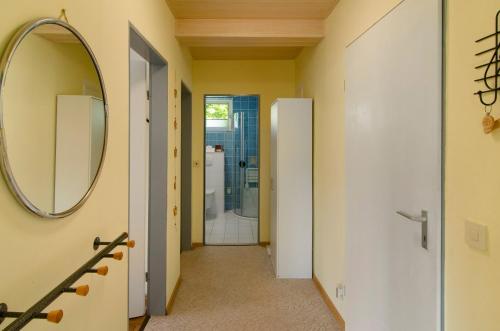 a hallway with a mirror and a bathroom at Harzblick am Waldesrand in Hahausen