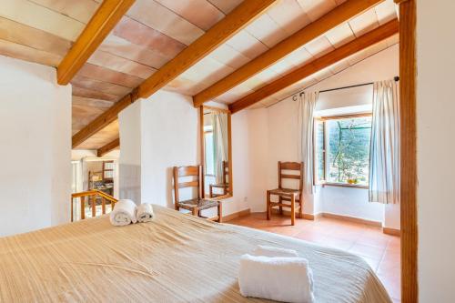 a bedroom with a bed with two towels on it at Can Jaumins in Sóller