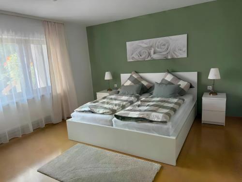 a bedroom with a large white bed in a room at Komfort trifft Natur in Albbruck