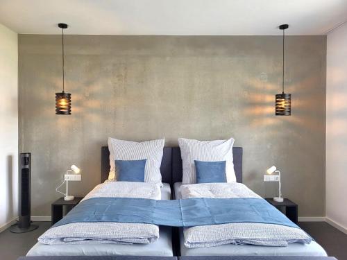 a bedroom with two beds with blue and white pillows at Ferienhaus Schlossterrassen 8a in Pouch