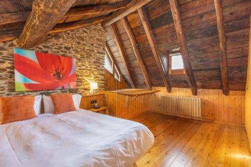 a bedroom with a bed in a room with wooden ceilings at Cobert de Felip in Gavas
