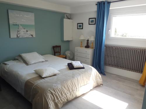 a bedroom with a large bed and a window at Maison D'hôtes en Drôme Provençale in Vinsobres