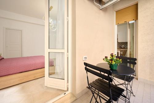 a small table and chairs in a room with a bed at Casa La Viola - Follonica in Follonica