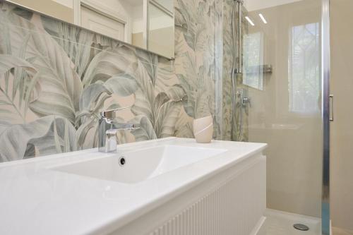a bathroom with a white sink and a shower at Casa La Viola - Follonica in Follonica