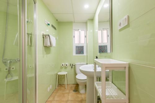 a bathroom with a toilet and a sink and a shower at Entreplayas Benidorm in Benidorm