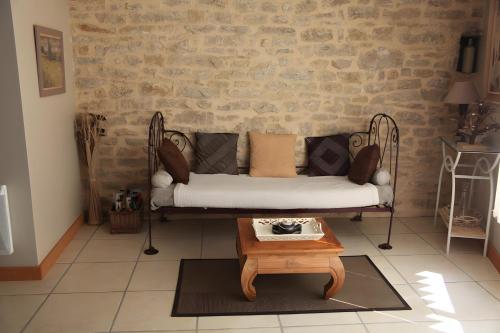 a living room with a couch and a coffee table at Gite Les Trois Collines in Cuisiat