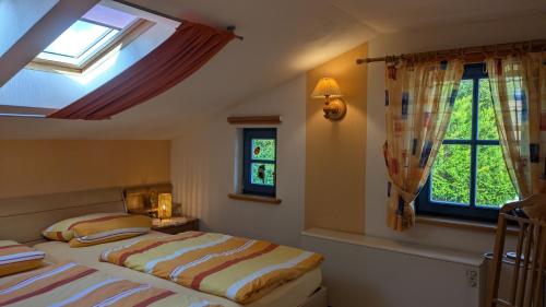 a bedroom with a bed and two windows at Märchengarten Fischer un sin Fru in Putbus