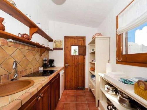 a kitchen with a sink and a counter top at Villa Rocío in Binibeca