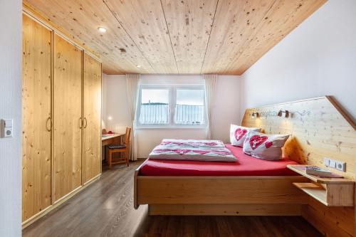 a bedroom with a bed with a wooden ceiling at Hochtalblick - Fewo Oren in Bernau im Schwarzwald