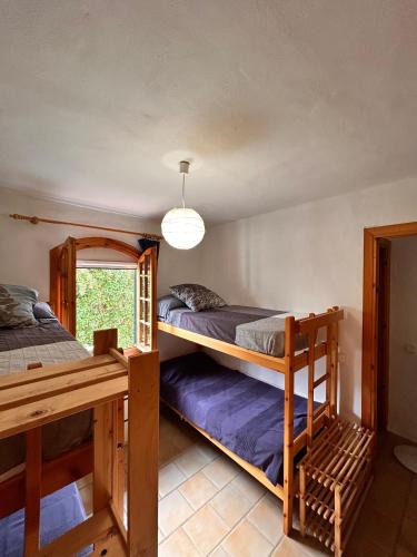 a bedroom with two bunk beds and a window at Casa Reija in Son Parc